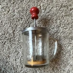 Glass Nut Chopper 8 Oz With Stainless Steel Lid & Red Wood Handle, Coarse Blade. Fixed Price $12.00.