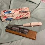 Vintage 70S Reeds Rocket Nut Cracker R-800 White Handle Oak Base Little Ar. Fixed Price $14.50.