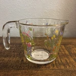 New Dolly Parton 2 Cup Measuring Glass Spring Wildflower Pattern. Fixed Price $19.95.