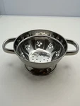 Sitlax Stainless Steel 6 1/4 Colander Strainer W/ Cherry Silhouette Cutouts. Fixed Price $10.00.